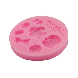 Pink silicone mold with pumpkin and witch hat shapes for Halloween baking and DIY crafts