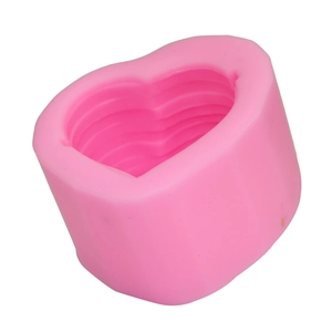 Detailed macro view of pink silicone heart mold with tiered interior for candle making