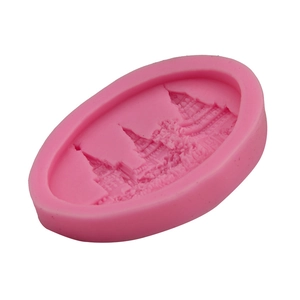 Macro detail of a pink silicone mold with an intricate European castle relief design