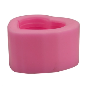 Macro view of pink heart-shaped silicone mold for DIY soap candles and baking crafts