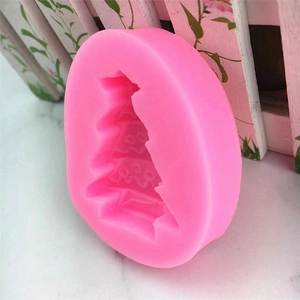 Pink silicone Christmas tree cake mold with star and wave details for DIY baking