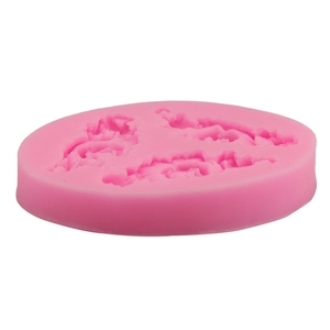 Detailed close-up of pink round silicone mold with three flower and leaf cavities for baking
