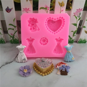 Pink silicone mold for heart, flowers and dress shapes with finished fondant samples