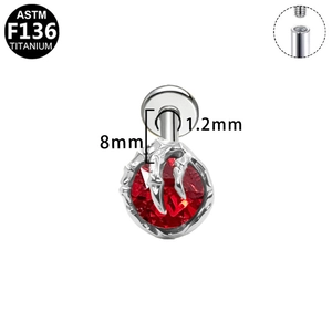 Macro detail of G23 titanium heart bat wing stud with red gemstone and internal threading