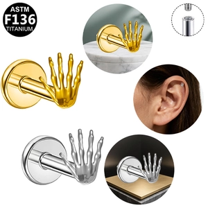 Detail of G23 titanium skull hand ear stud with internal threading and color options