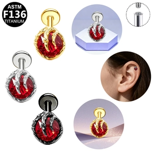 Detailed macro view showing G23 titanium dragon claw stud earring with red gemstone