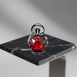 Macro view of G23 titanium gothic claw stud earring with a vibrant red gemstone inlay