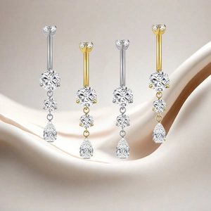 Detailed macro view of F136 titanium belly rings with vertical pear-shaped zircon stones