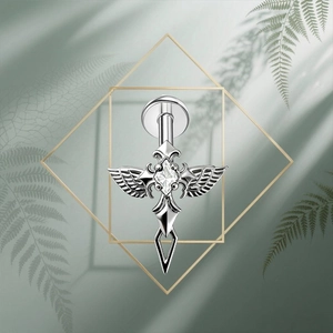 Macro detail of G23 titanium gothic cross stud earring with zircon inlay and wings