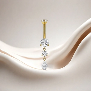 Detailed view of a gold titanium belly ring with sparkling zircon stones and pear drop