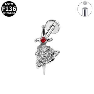 Detailed macro view of G23 titanium rose and sword ear stud with red zircon stone