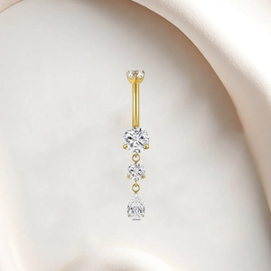 Macro view of gold-plated titanium belly ring with descending zircon studs and teardrop charm