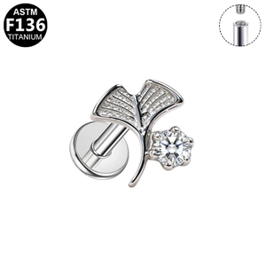Detail of G23 titanium labret stud featuring a zircon leaf design and internal threading
