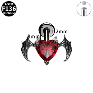 Detailed view of G23 titanium bat wing ear stud with a red heart-shaped gemstone