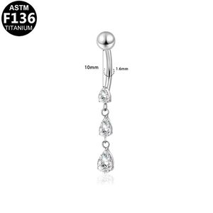 Macro detail of F136 titanium belly ring with dangling three-tier teardrop cubic zirconia