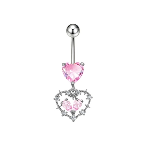 Dettaglio di piercing all'ombelico con cuore rosa e ciondolo a spina d'argento