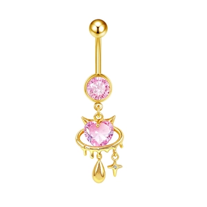 Macro detail of gold belly ring with pink heart zircon and sparkling star pendant