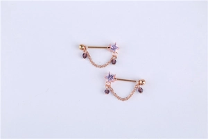 Detail of rose gold nipple rings featuring purple star zircon and elegant bead chains