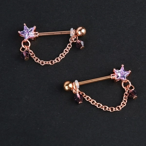 Rose gold nipple barbells with purple star crystals and dangling chains on black background