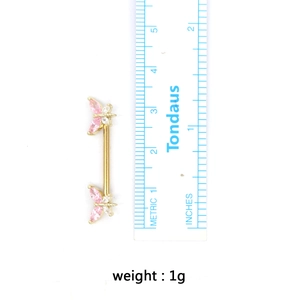 Golden dragonfly nipple ring with pink zircon stones and size measurement ruler