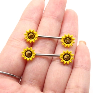 Detailed close-up of sunflower barbell body jewelry with bright yellow petals and silver bars