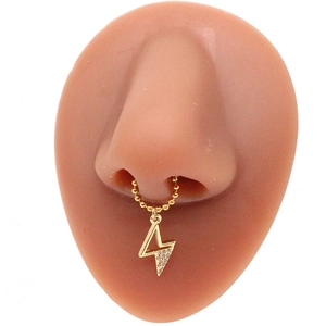Detailed view of a gold nose ring with a bead chain and sparkling lightning bolt pendant