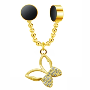 Detailed view of golden butterfly pendant with small rhinestones and black magnetic studs