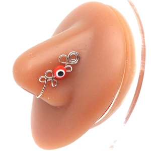 Handmade silver wire evil eye nose cuff clip-on jewelry shown on a silicone model