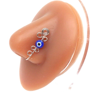 Detailed wire-wrapped evil eye non-pierced nose ring on silicone display model