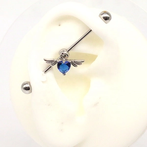 Silver industrial barbell with heart blue gemstone and angel wings on silicone ear model