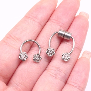 Detail of horseshoe magnetic nose rings with rose floral ends and small zircon stones