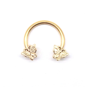 Golden stainless steel horseshoe nose ring featuring detailed butterfly ornaments on both ends