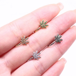 Macro view of micro-pave rhinestone cannabis leaf clip-on nose rings in four colors
