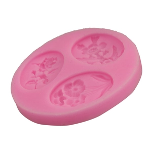 Macro detail of a 3-cavity pink silicone mold featuring intricate floral petal patterns