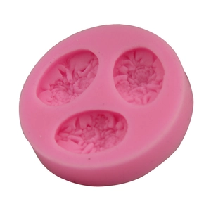 Detail of pink silicone mold featuring three distinct peony and succulent floral shapes