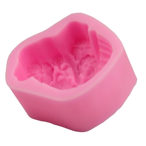 Detailed view of pink silicone mold with floral relief for DIY fondant and baking