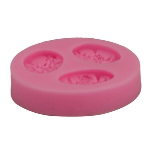 Detailed view of pink silicone mold with three different rose flower cavities for DIY baking