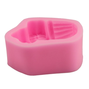 Macro view of a pink silicone cupcake mold featuring fine vertical striped texture detail