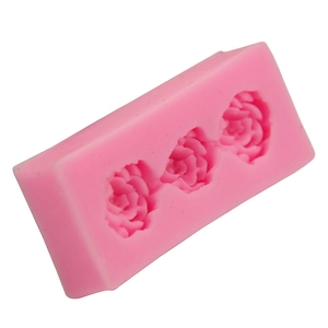 Detailed macro view of pink silicone mold featuring three intricate 3D rose flower cavities