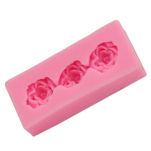 Detailed close-up of pink silicone mold with three interconnected rose flower shapes