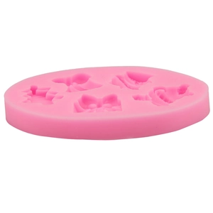 Detailed macro view of pink silicone mold featuring bow and bouquet shaped cavities