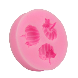 Detail of round pink silicone mold with three leaf-shaped cavities for DIY baking