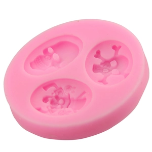 Pink silicone mold featuring three distinct skull designs for Halloween cake decorating