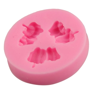 Close-up of pink round silicone mold with three petal leaf cavities for cake baking