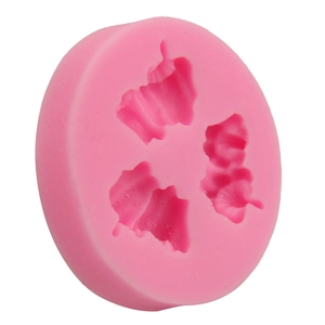 Macro detail of pink round silicone mold featuring three leaf and petal cavities for baking