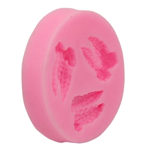 Detailed macro view of pink silicone mold featuring three distinct leaf vein textures