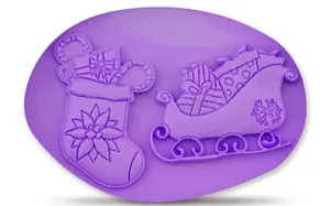 Purple silicone mold featuring detailed Christmas stocking and sleigh designs for baking