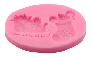 Pink silicone Christmas mold with Santa sleigh and snowflake stocking shapes