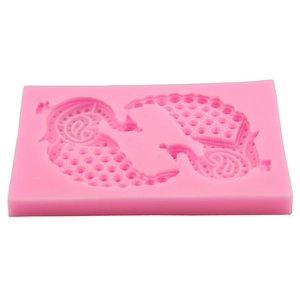 Close-up of pink silicone peacock mold for fondant and DIY cake decorating tools