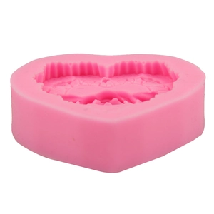 Close-up of pink heart silicone mold with intricate floral lace pattern for DIY baking